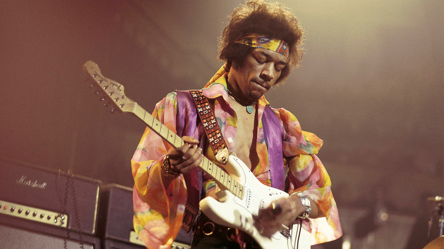 Guitarist Jimi Hendrix performing with an electric guitar.